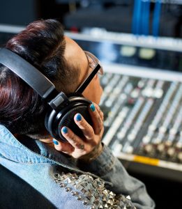 Audio engineer working at mixing console